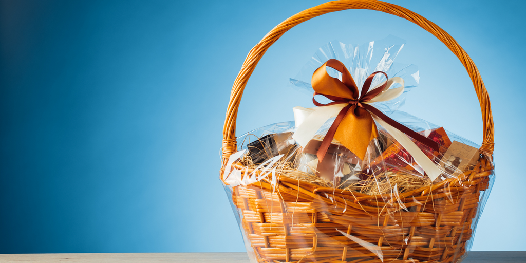 food gift hamper in basket with blue background